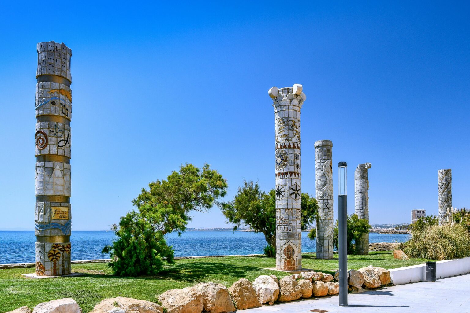 Mosaic columns by the Mediterranean Sea with clear sky in Torrevieja, Spain.