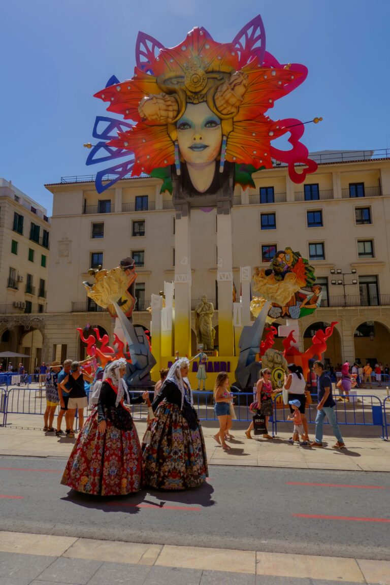 Vibrant festival scene in Alicante featuring traditional costumes and colorful decorations.
