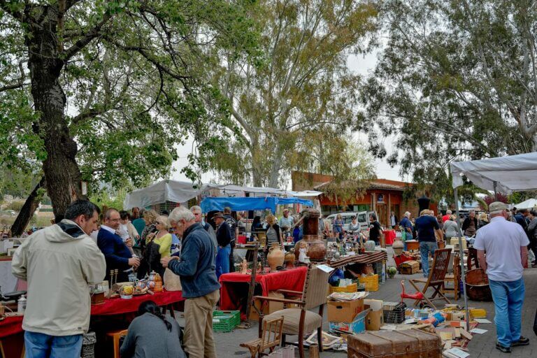 Jalón Saturday Market in Xaló, Costa Blanca with stalls selling antiques, crafts, and local produce surrounded by mountains.