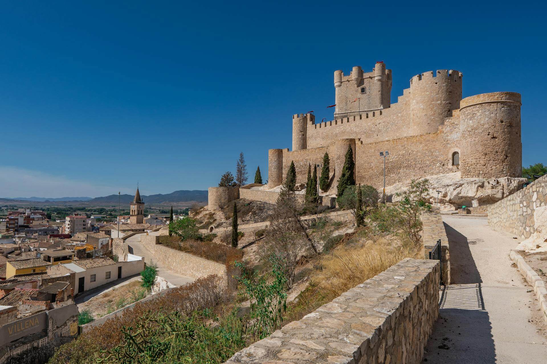 View of Villena’s Medieval Castle in Costa Blanca, Spain, perched on a hill overlooking the town.